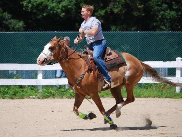 A rider and horse captured mid-gallop at a Connecticut Barrel Horse event.