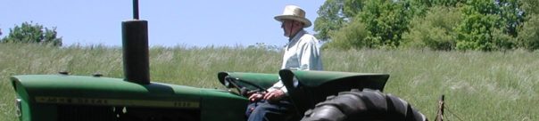 On his tractor, ready to mow.