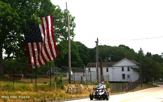 Big flag. The rider is on a three-wheeled vehicle - not two, not four in Lyme, Connecticut. Photo © Moo Dog Press.