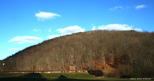 Chauncey Peak is out of the picture to the extreme right side of this image of the Guiffrida Park dam in Meriden, Conn., but behind the mountain seen here is an open quarry. The Chauncey Peak trail skirts the excavations and gives a view of the negative space.