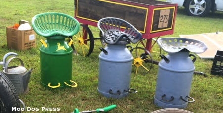 Milkcans repurposed and sporting horseshoes for footrests. Ingenious.