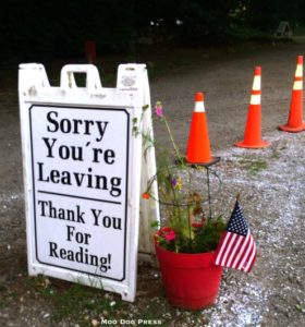 A sign and flag seen on the way out on a recent visit, happy and a bag full of books in hand.