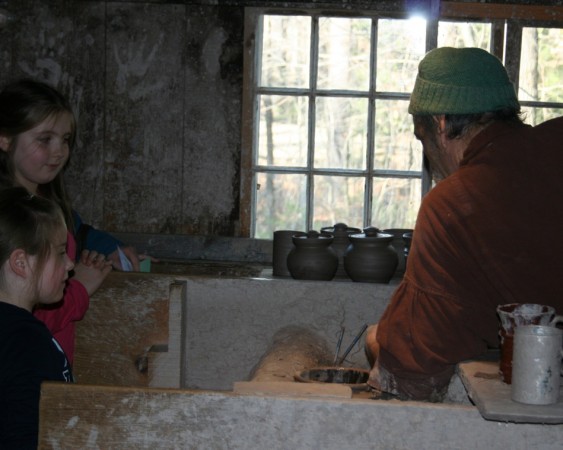 The potter at work in the village. Note the handprints in clay slip on the walls.