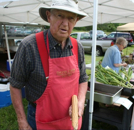 Whit Davis of Davis Farm with an ear of Indian flint corn at Dension Farm Market. Photo, Moo Dog Press